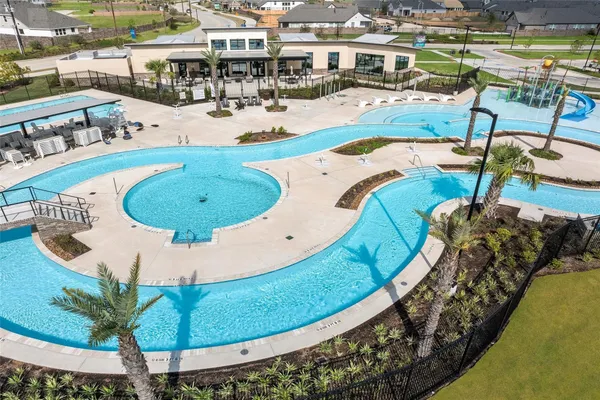 an aerial view of a swimming pool with outdoor seating