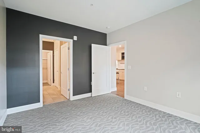 an empty room with entrance and windows