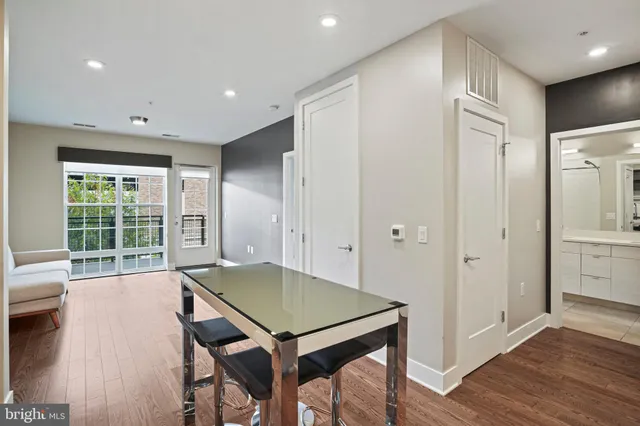 a kitchen with stainless steel appliances granite countertop a stove a sink dishwasher and a microwave oven with wooden cabinets