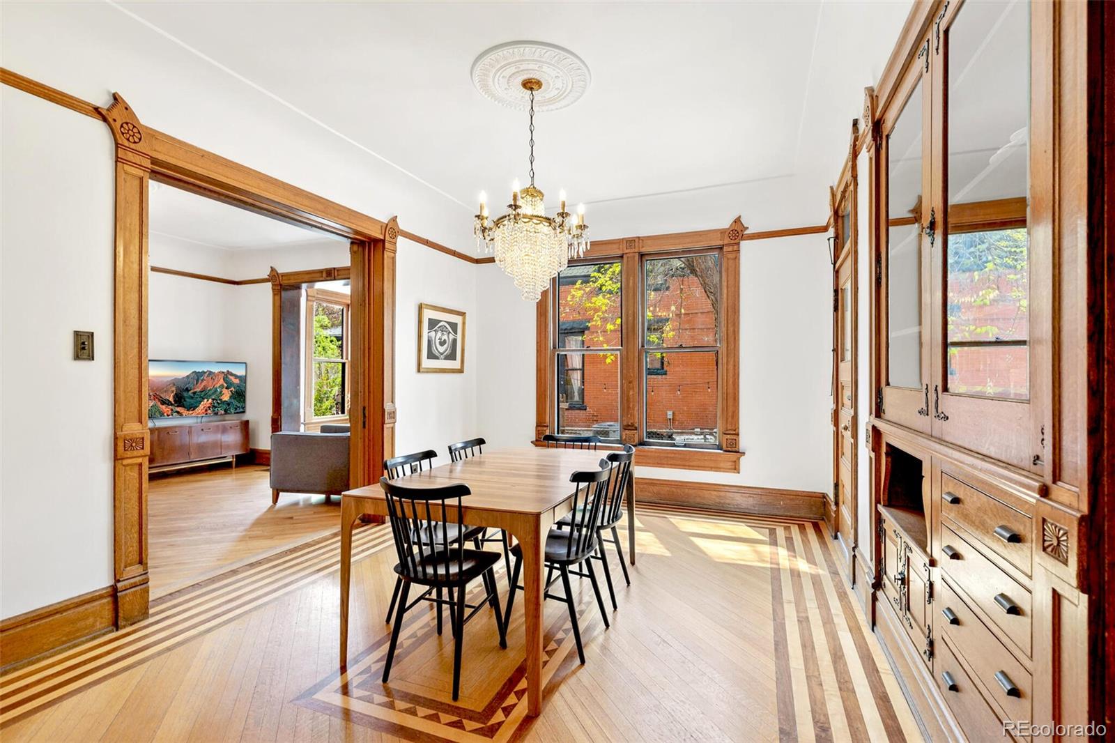 2851 Perry Street Denver, CO 80212 - Photo 19 of 50 a dining room with furniture a chandelier and wooden floor