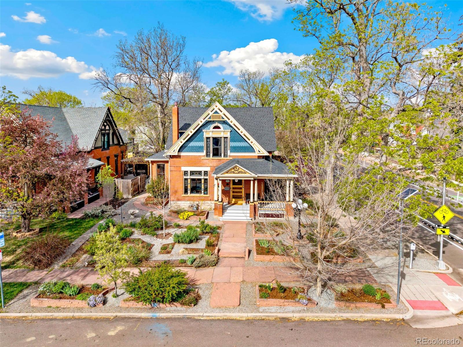 2851 Perry Street Denver, CO 80212 - Photo 2 of 50 a front view of a house with a yard and garage