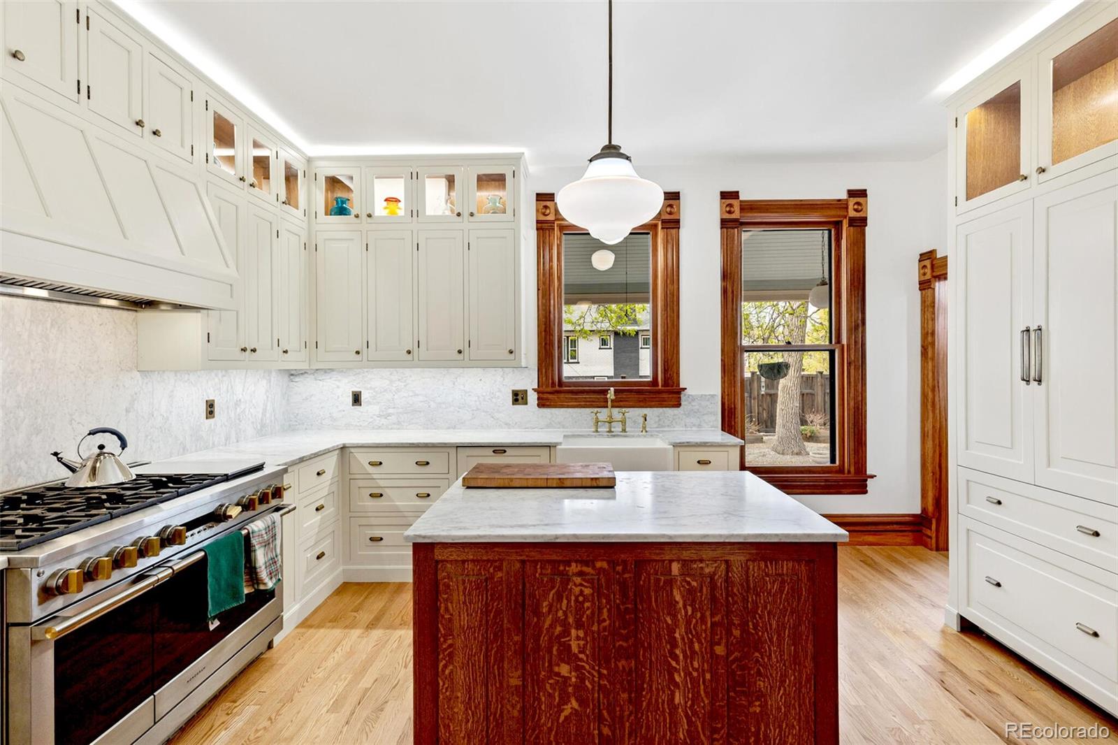 2851 Perry Street Denver, CO 80212 - Photo 24 of 50 a kitchen with a sink stove and wooden cabinets