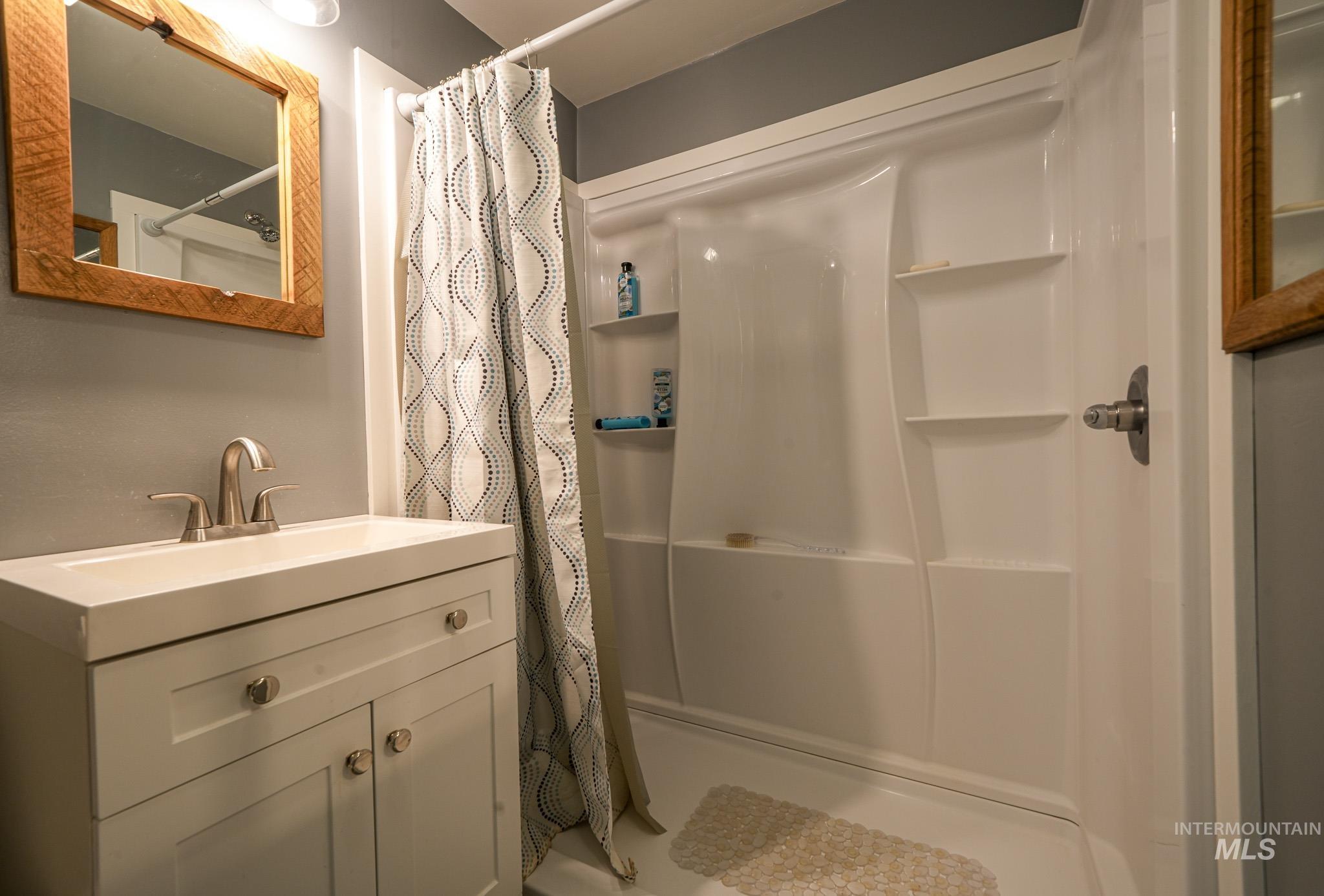 67 Jessup Road Grangeville, ID 83530 - Photo 32 of 49 White vanity with brushed nickel hardware, integrated sink, and brushed nickel faucet