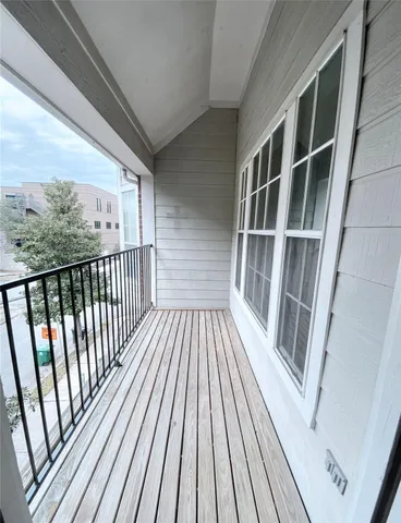 a view of balcony with wooden floor