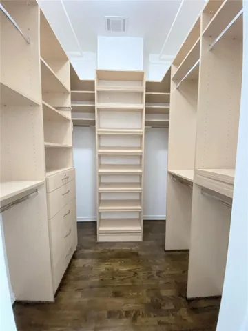 a view of walk in closet with empty racks