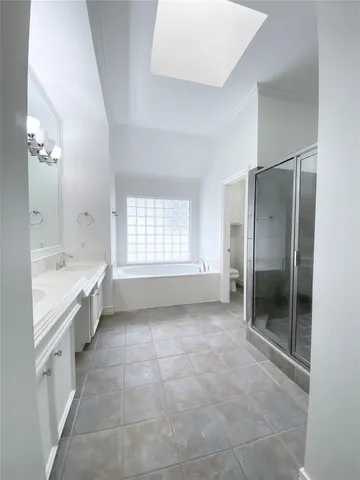 a large bathroom with a large tub shower and checkered floor