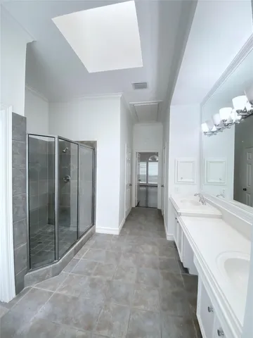 a spacious bathroom with a bathtub sink and mirror
