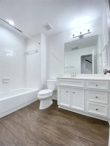 a bathroom with a sink a toilet and a bathtub