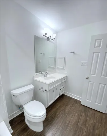 a bathroom with a double vanity sink toilet and mirror