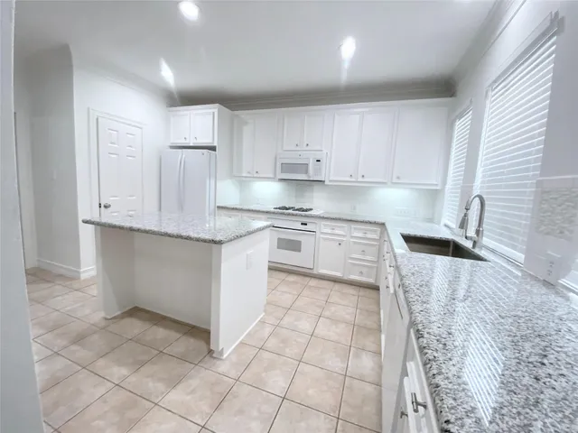 a kitchen with stainless steel appliances granite countertop a sink and cabinets