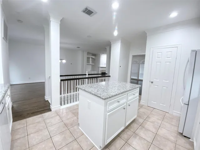 a kitchen with granite countertop a sink and cabinets