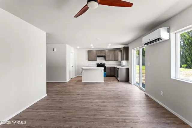a view of a kitchen with a sink and an empty room