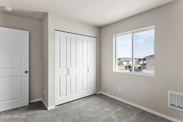 a bathroom with a granite countertop sink a toilet and a large mirror