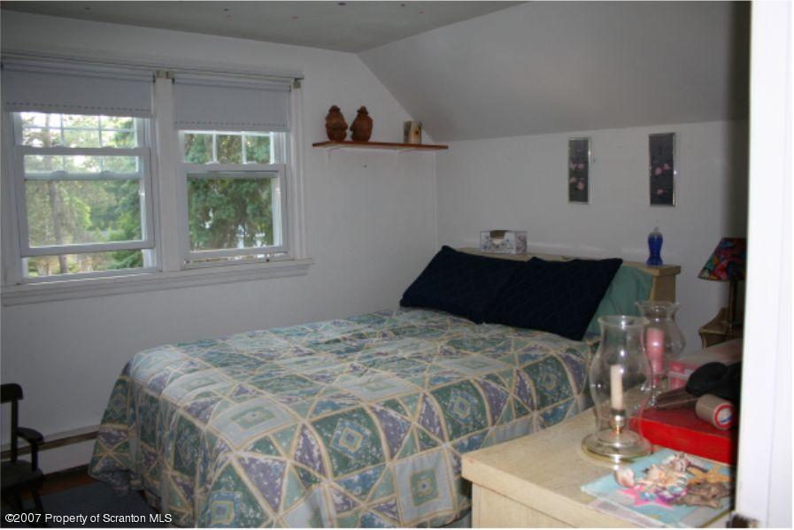 181 Falls Road Falls, PA 18615 - Photo 2 of 16 a bedroom with a bed and a window