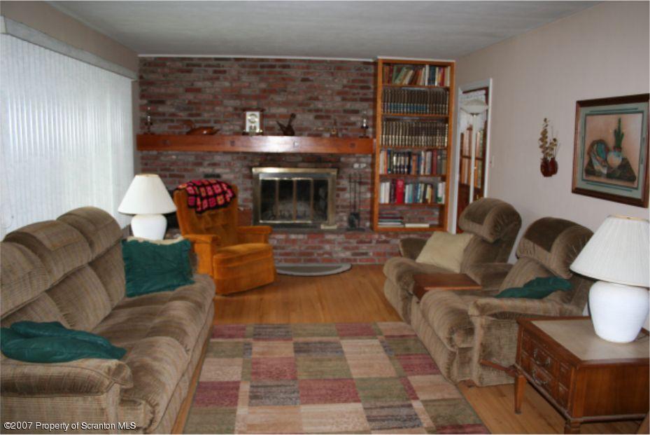 181 Falls Road Falls, PA 18615 - Photo 6 of 16 a living room with furniture and a fireplace