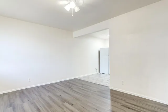 a view of an empty room with wooden floor