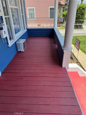 a balcony with wooden floor and furniture