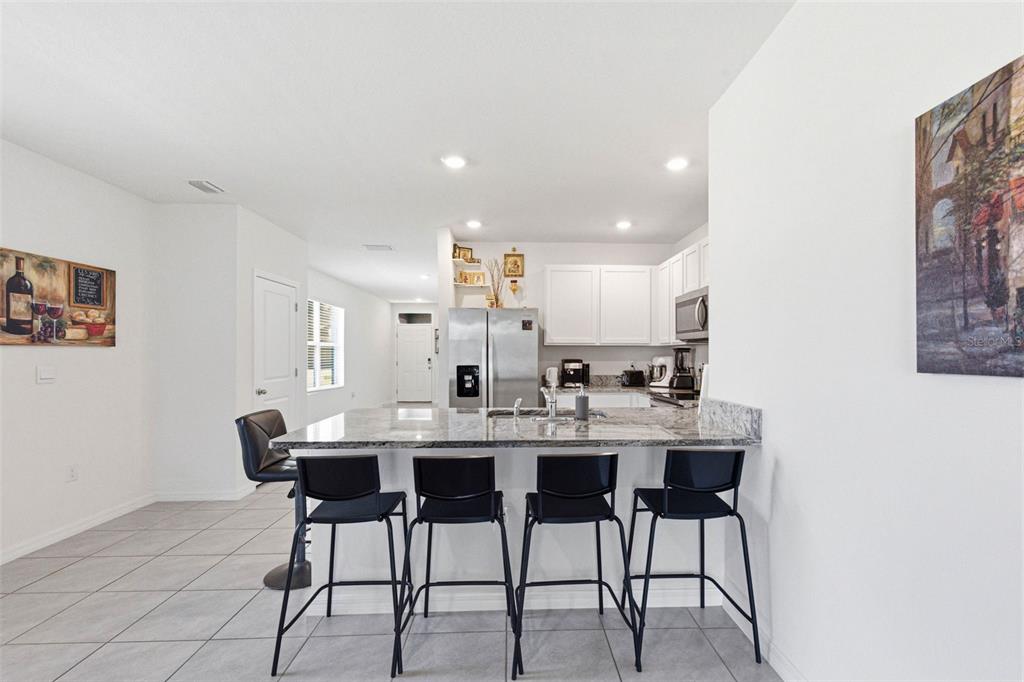 2959 Common Fig Run Wesley Chapel, FL 33543 - Photo 11 of 36 a view of a dining room with furniture