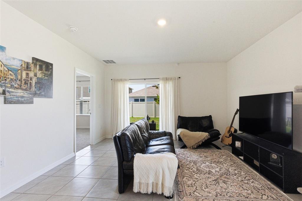 2959 Common Fig Run Wesley Chapel, FL 33543 - Photo 13 of 36 a living room with furniture and a flat screen tv