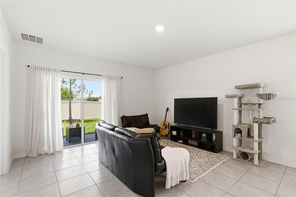 2959 Common Fig Run Wesley Chapel, FL 33543 - Photo 14 of 36 a living room with furniture and a flat screen tv
