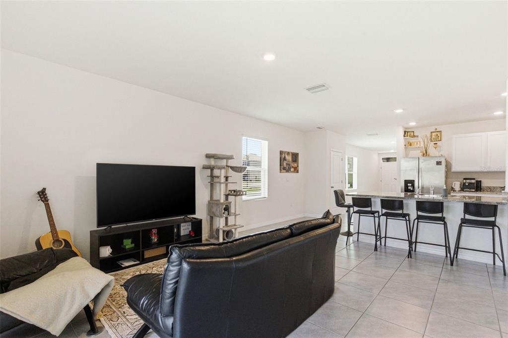 2959 Common Fig Run Wesley Chapel, FL 33543 - Photo 15 of 36 a living room with furniture and a flat screen tv