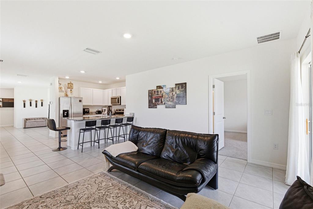 2959 Common Fig Run Wesley Chapel, FL 33543 - Photo 16 of 36 a living room with furniture and kitchen view