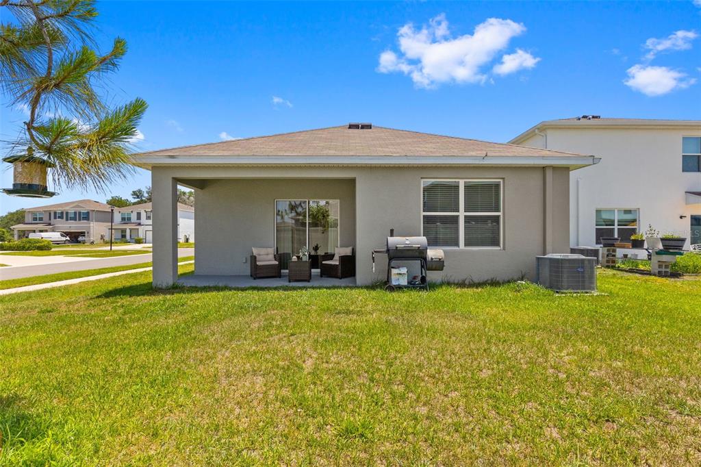 2959 Common Fig Run Wesley Chapel, FL 33543 - Photo 18 of 36 a view of a house with swimming pool and a yard