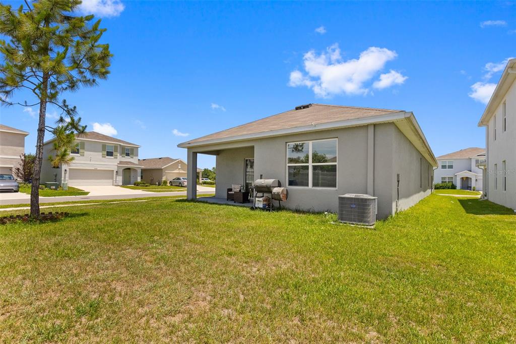 2959 Common Fig Run Wesley Chapel, FL 33543 - Photo 19 of 36 a view of a house with backyard and sitting area