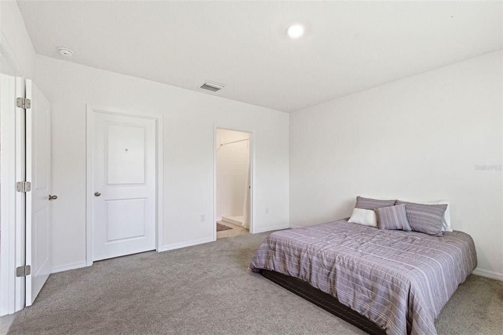 2959 Common Fig Run Wesley Chapel, FL 33543 - Photo 22 of 36 a bedroom with a bed and a closet