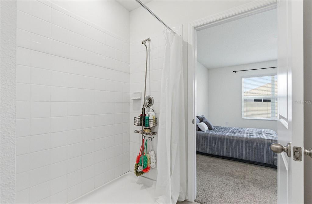 2959 Common Fig Run Wesley Chapel, FL 33543 - Photo 24 of 36 a bedroom with a bed and a window