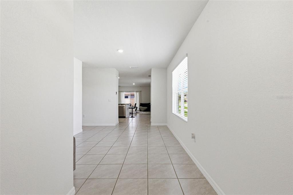 2959 Common Fig Run Wesley Chapel, FL 33543 - Photo 5 of 36 a view of empty room with wooden floor