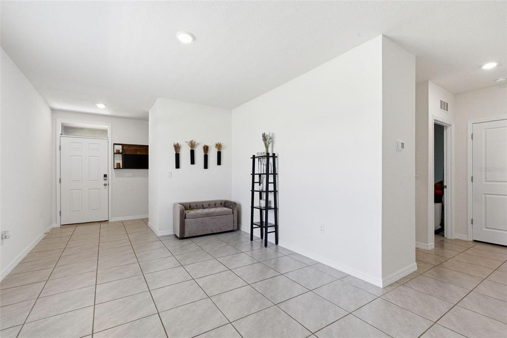 2959 Common Fig Run Wesley Chapel, FL 33543 - Photo 7 of 36 a room with furniture and mirror