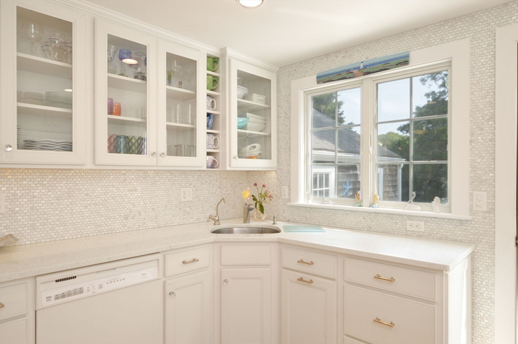 47 Great Bay Road Osterville, MA 02655 - Photo 15 of 38 a kitchen with stainless steel appliances white cabinets and a window