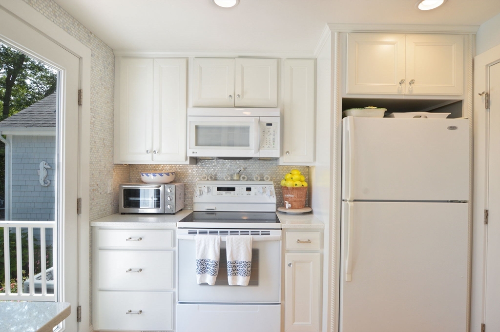47 Great Bay Road Osterville, MA 02655 - Photo 17 of 38 a white refrigerator freezer sitting in a kitchen