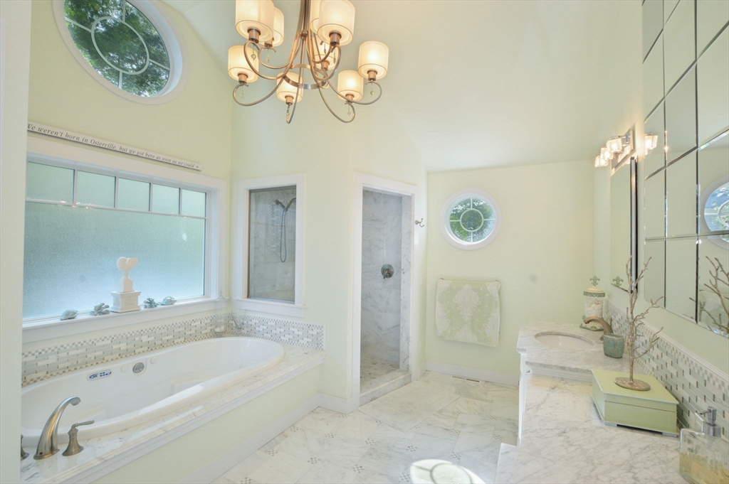 47 Great Bay Road Osterville, MA 02655 - Photo 20 of 38 a bathroom with a tub a sink and glass door shower