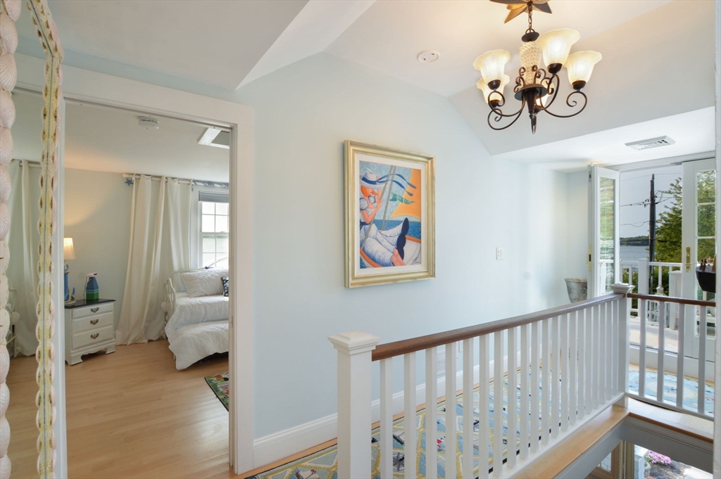 47 Great Bay Road Osterville, MA 02655 - Photo 26 of 38 a view of a hallway with windows and chandelier