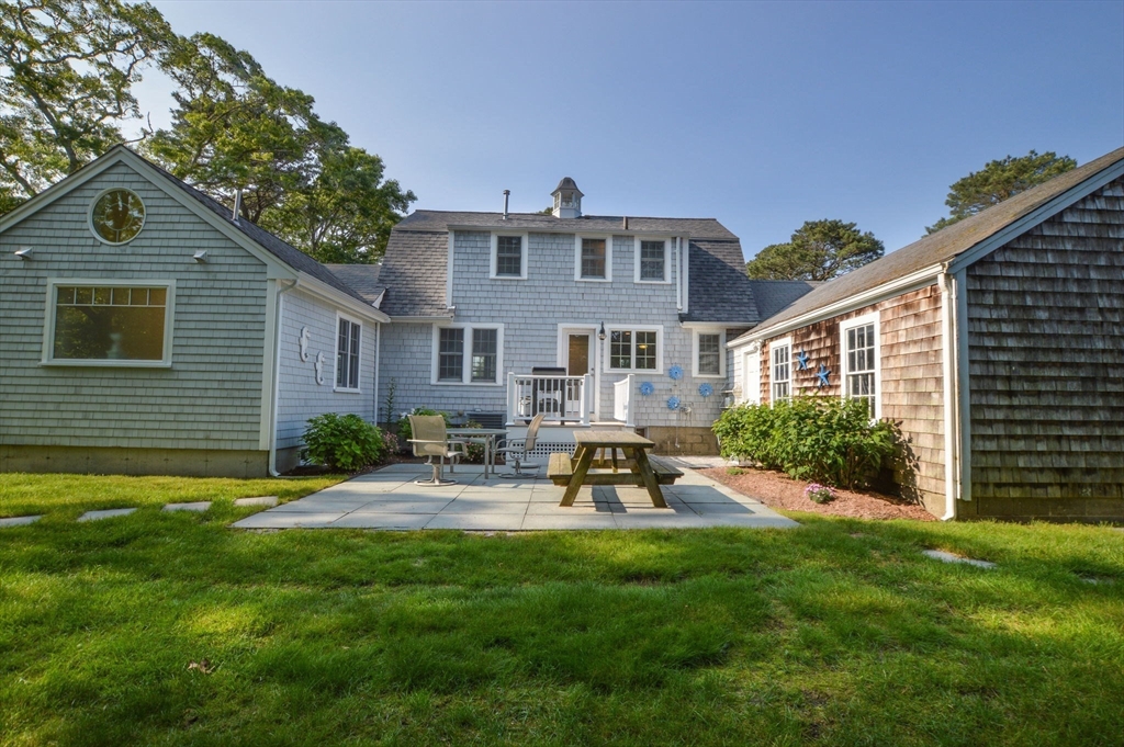 47 Great Bay Road Osterville, MA 02655 - Photo 29 of 38 a front view of a house with a yard and chairs
