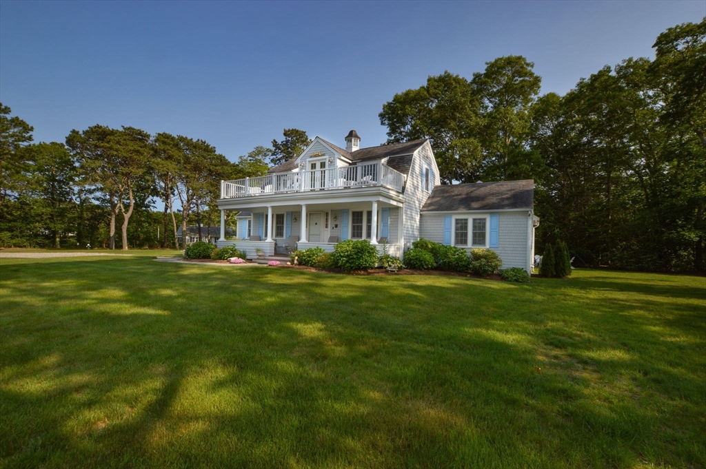 47 Great Bay Road Osterville, MA 02655 - Photo 4 of 38 a front view of a house with a garden