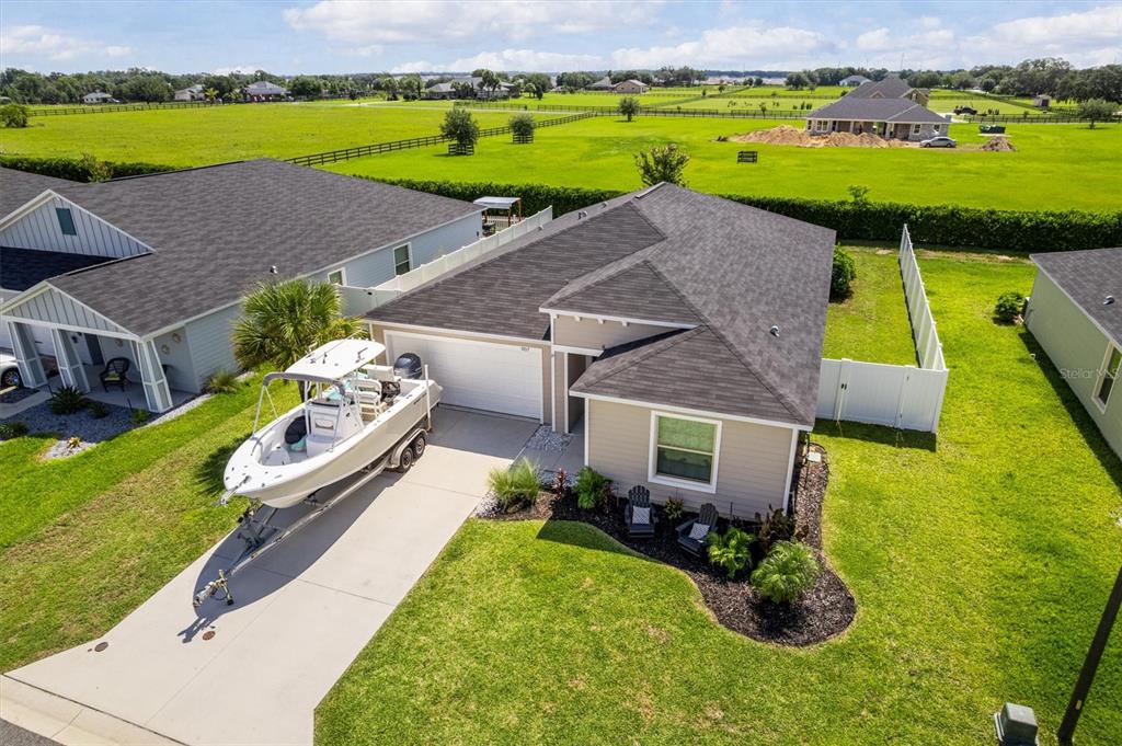 an aerial view of a house with a garden and swimming pool