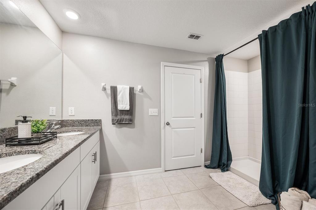 9217 Southwest 58th Circle Ocala, FL 34476 - Photo 13 of 21 a bathroom with a granite countertop sink and a mirror