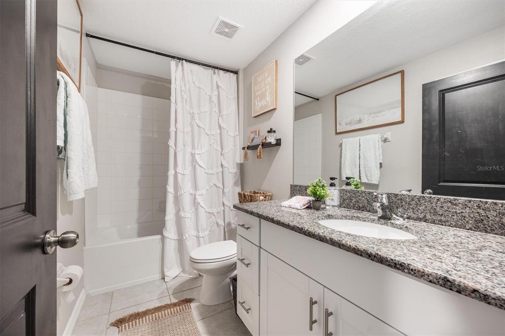 9217 Southwest 58th Circle Ocala, FL 34476 - Photo 16 of 21 a bathroom with a granite countertop sink toilet and shower