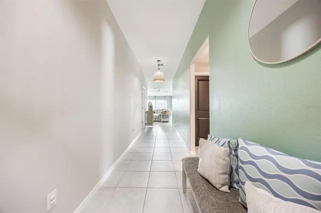 a hallway with a bed and a mirror