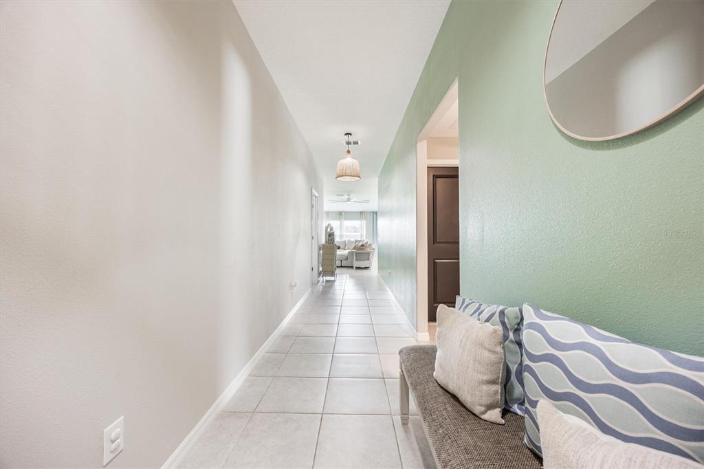 9217 Southwest 58th Circle Ocala, FL 34476 - Photo 7 of 21 a hallway with a bed and a mirror