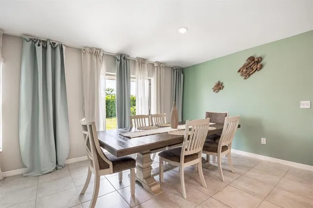 a view of a dining room with furniture and window