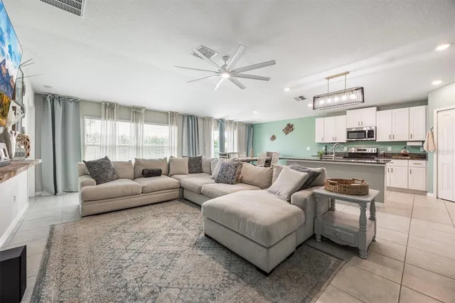 a living room with furniture and kitchen view