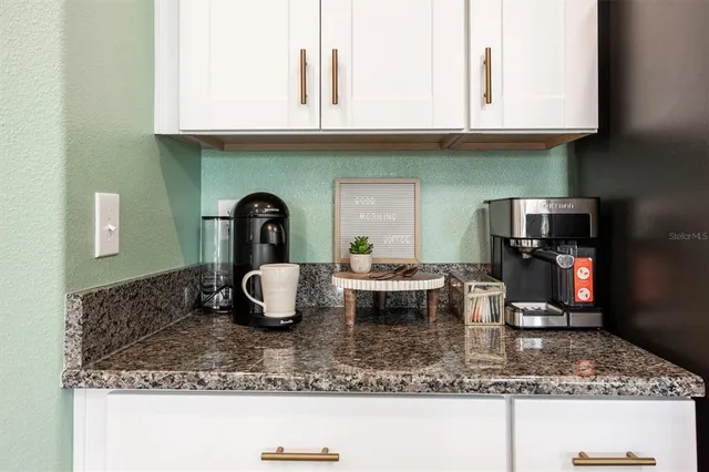 a kitchen with kitchen island granite countertop a sink and granite counter tops