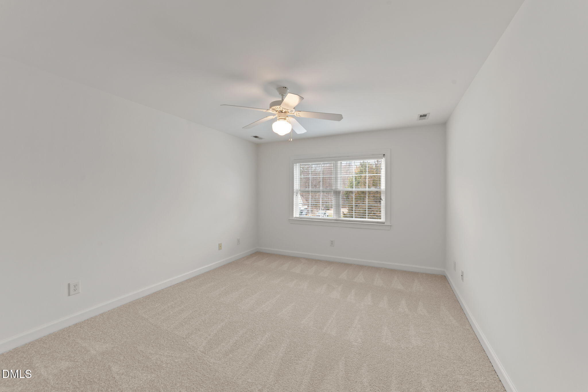 7101 Numa Circle Willow Spring, NC 27592 - Photo 19 of 44 an empty room with a window and a fan