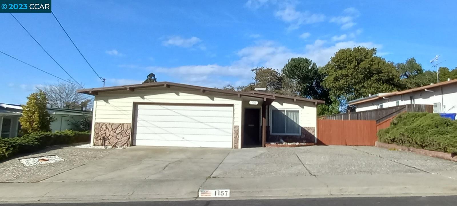 1157 Rising Glen Road Pinole, CA 94564 - Photo 1 of 1 a front view of a house with a yard and garage