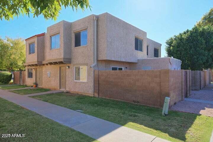 600 South Dobson Road, Unit 69 Mesa, AZ 85202 - Photo 1 of 24 a front view of a house with a garden