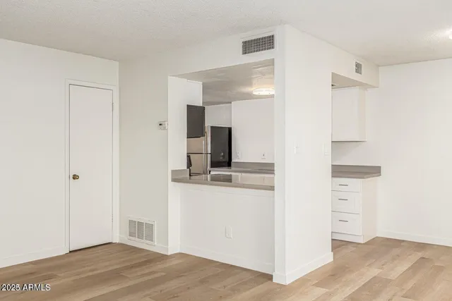 a view of a kitchen with wooden floor